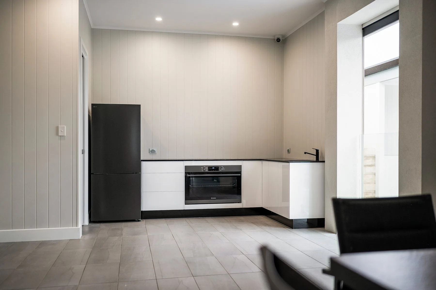 Alfresco kitchen with integrated fridge and stone benchtops