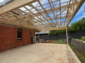 New pergola roof frame built over existing paving at the rear of a home