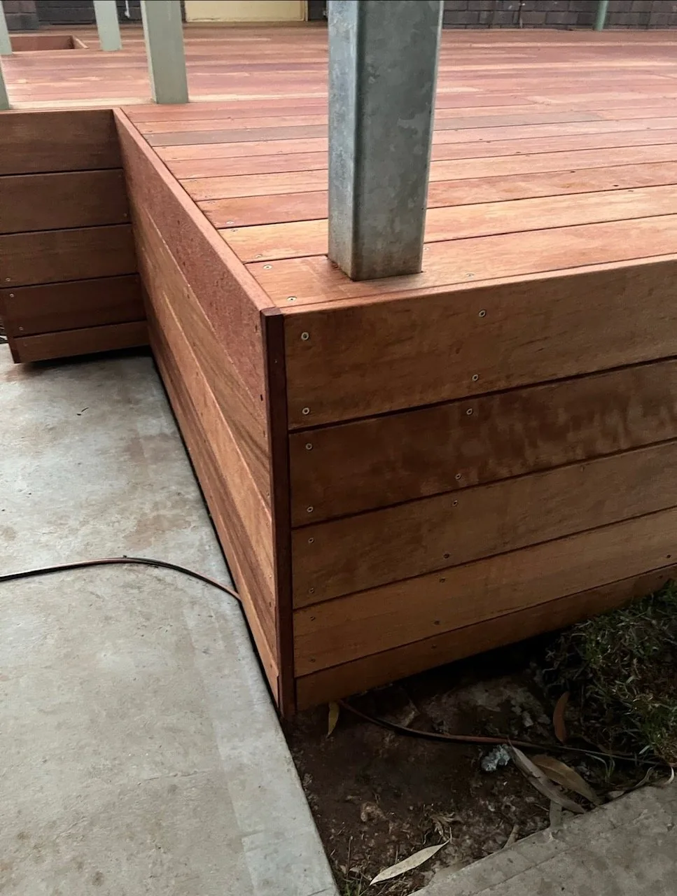 Hardwood decking and bench seating built around a steel post
