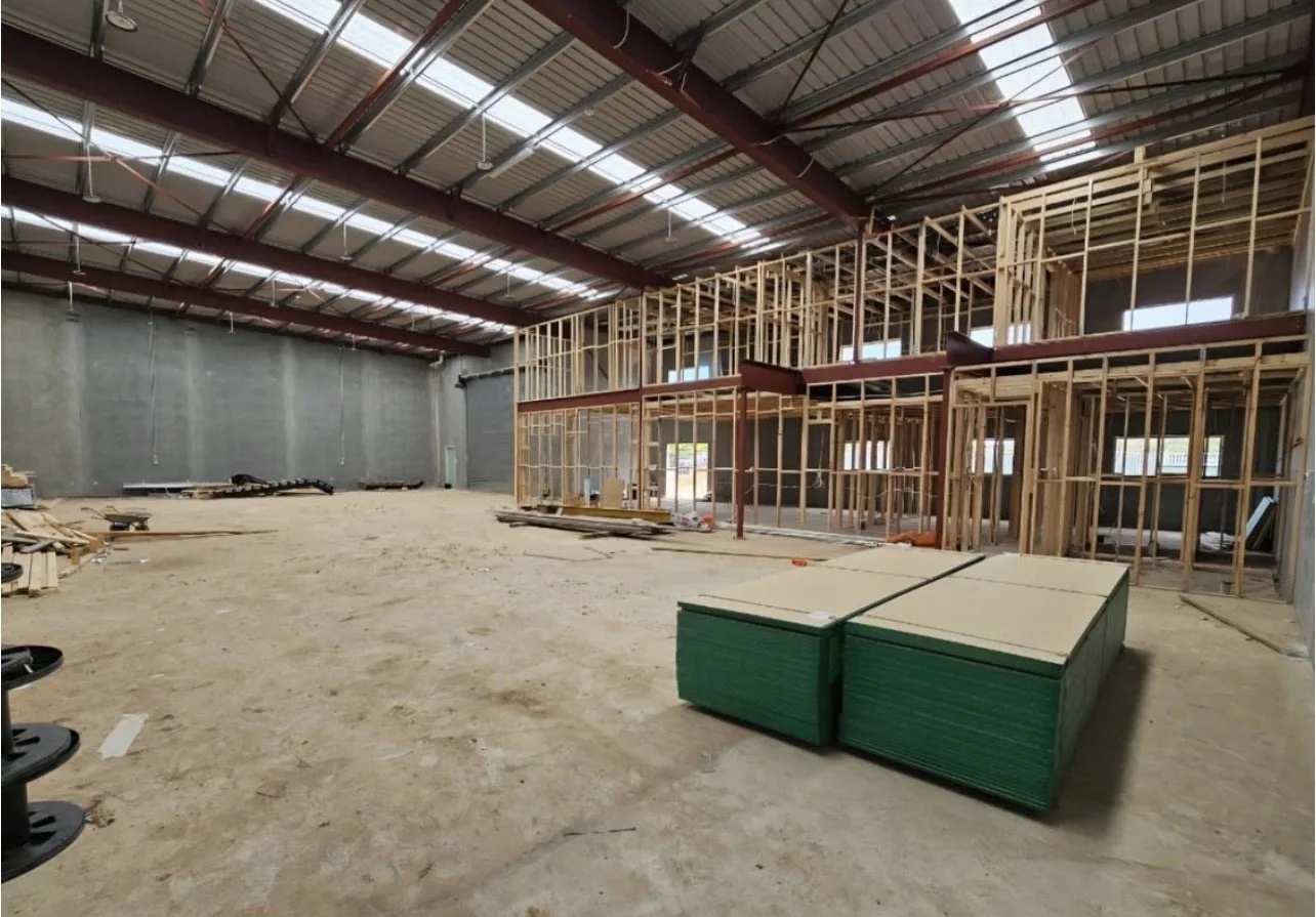 New stud framing standing inside an existing warehouse shell